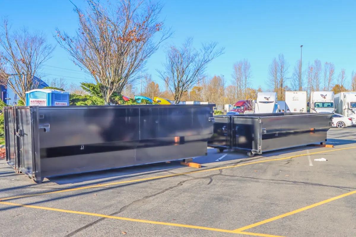 Professional dumpster rental service with roll-off container on residential driveway in Carpentersville